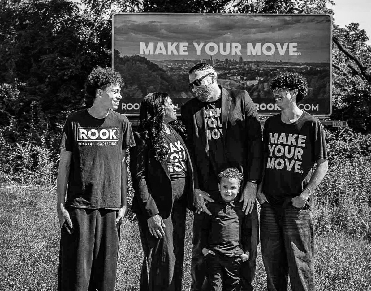 The ROOK family in front of the MAKE YOUR MOVE billboard